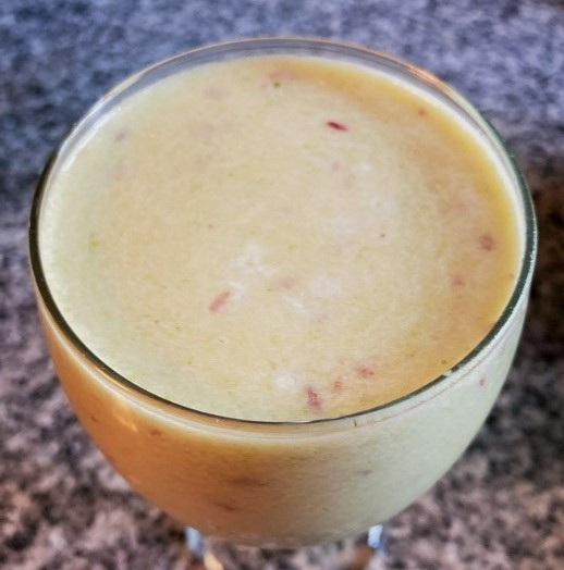 Glass containing light-colored smoothie
