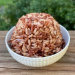 Cooked brown and red rice in a white bowl