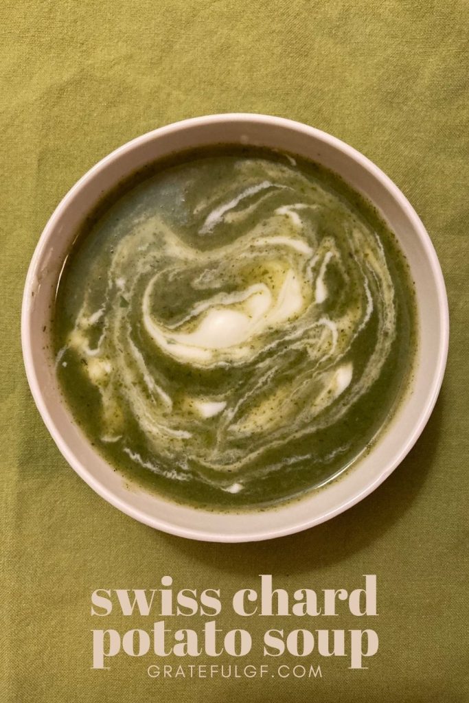 Swiss chard potato soup with yogurt garnish, green background