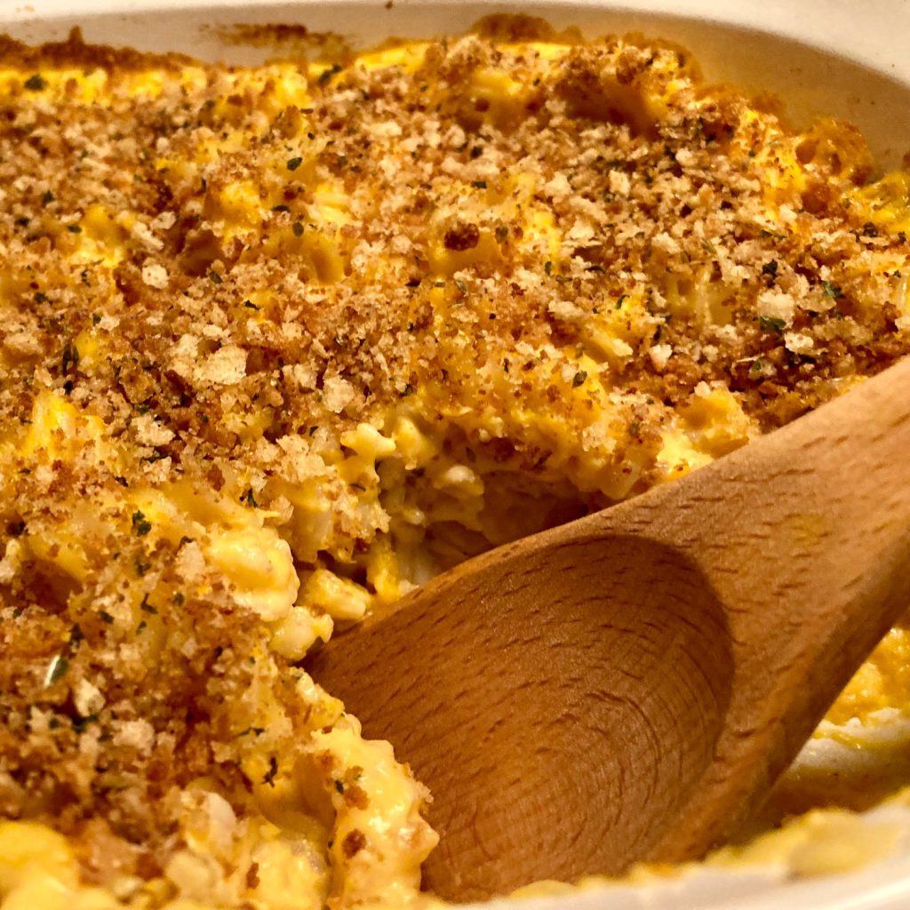 baked sweet potato mac and cheese with wooden spoon