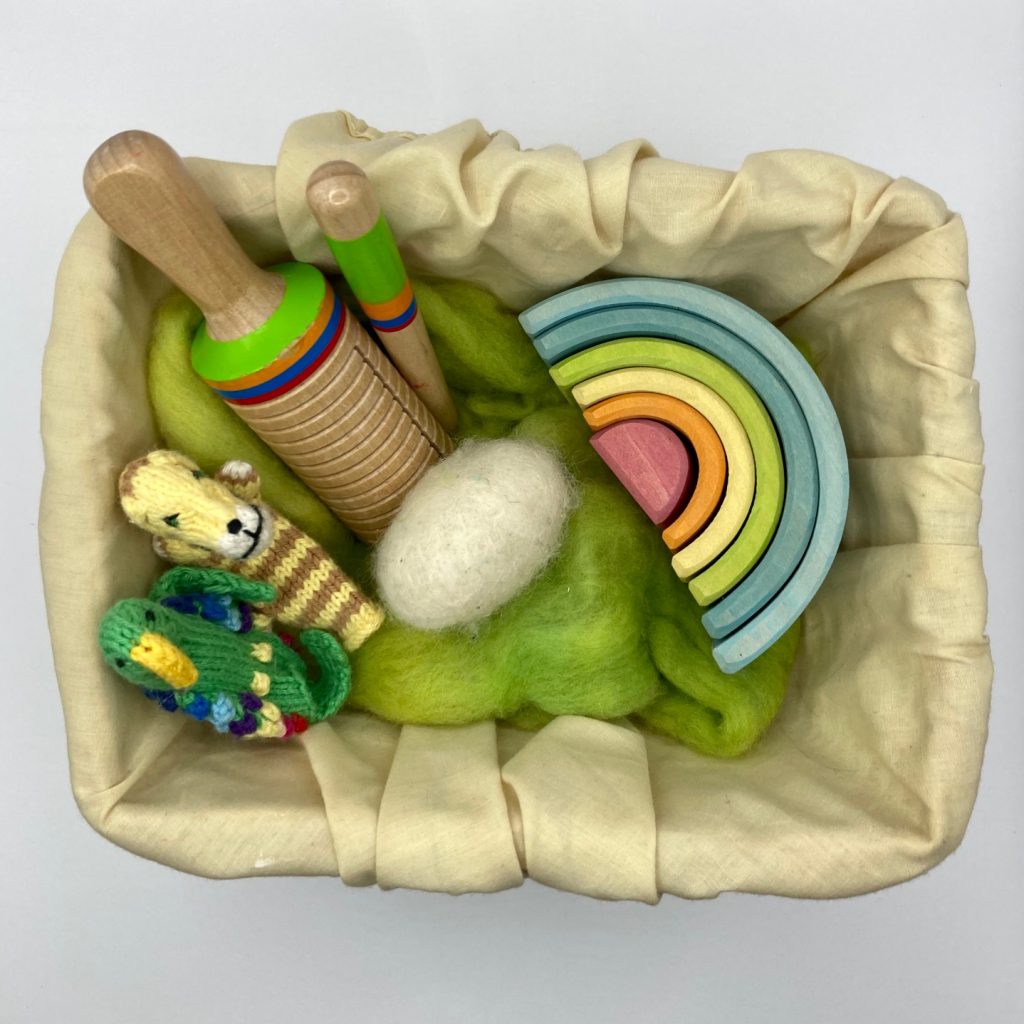Easter basket with finger puppets, percussion instrument and wooden rainbow