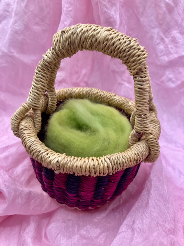 bolga basket with green wool roving