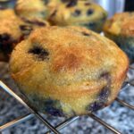 coconut flour blueberry muffin cooling on rack