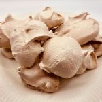 chocolate meringue cookies on a white plate
